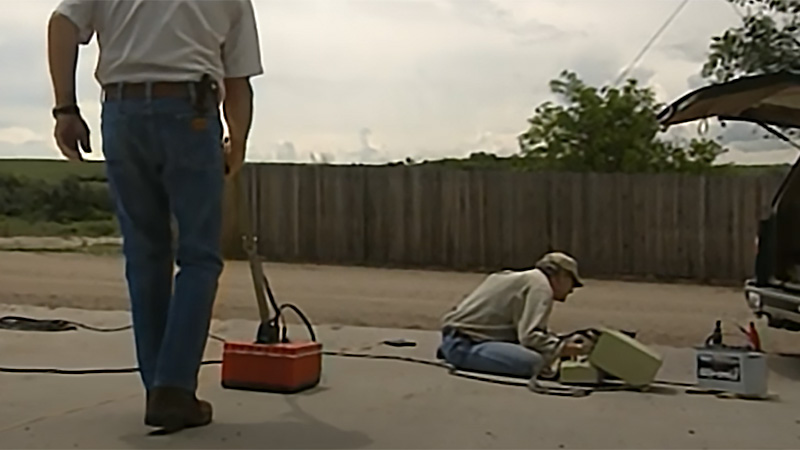Technicians using ground-penetrating radar to locate a grave
